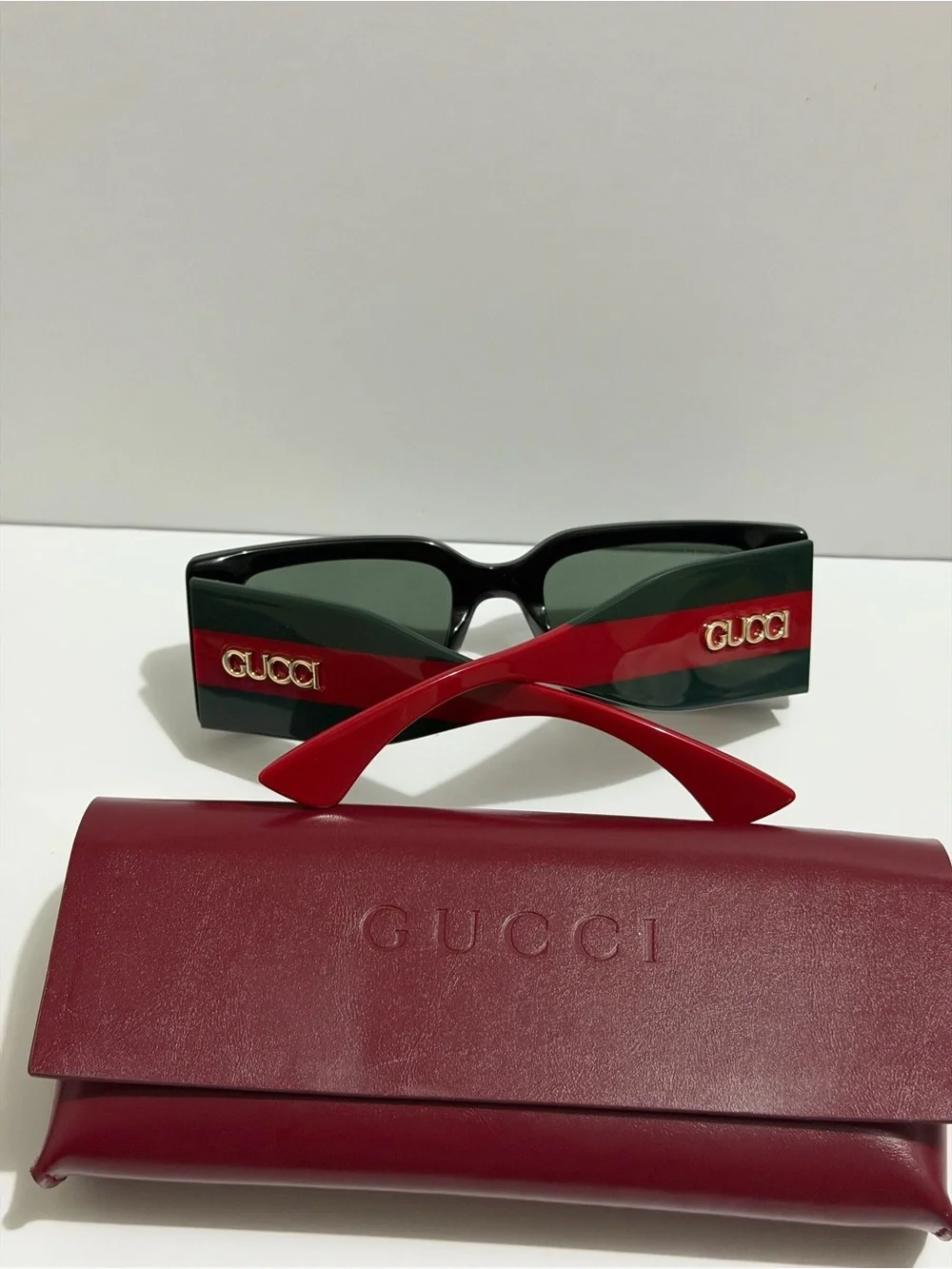 Gucci Black Frame Sunglasses with Red Temples and Gold Logo